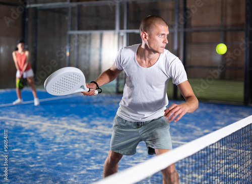 Man playing padel tennis on the padel court © JackF