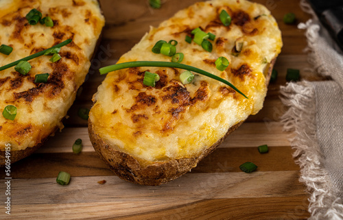 Cheesy twice-baked potato garnished with chopped scallion