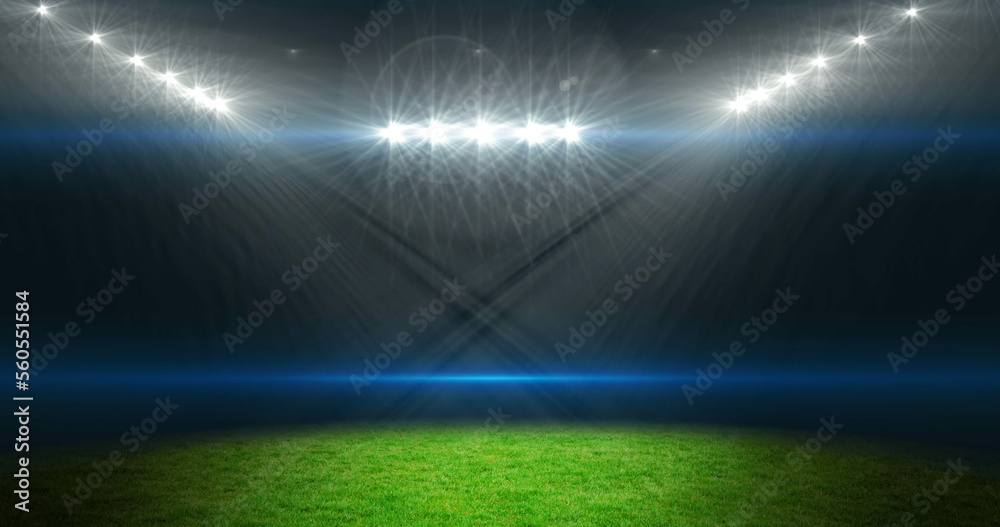 Image of empty sports stadium with glowing spotlights