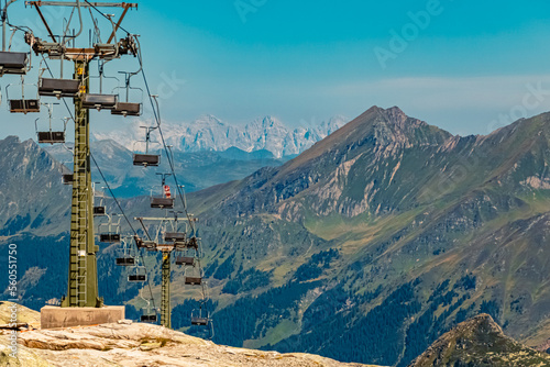 Beautiful alpine summer view with reflections in a lake and a chairlift at the famous Weisssee Gletscherwelt, Uttendorf, Salzburg, Austria photo