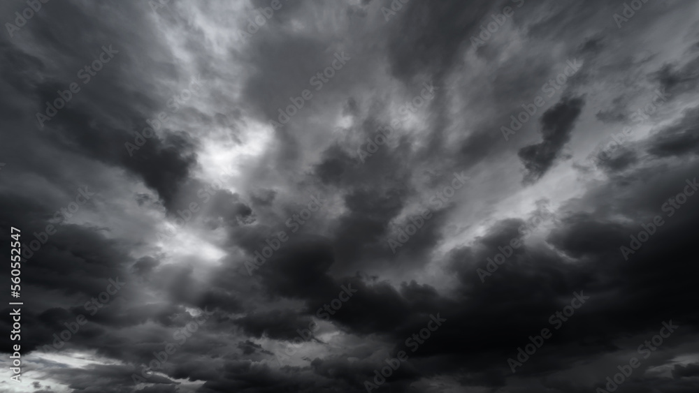 dark dramatic sky with black stormy clouds before rain or snow as abstract background, extreme weather, the sun shines through the clouds, high contrast photo dark dramatic sky with black stormy clouds before rain or snow as abstract background, extreme weather, the sun shines through the clouds, high contrast photo