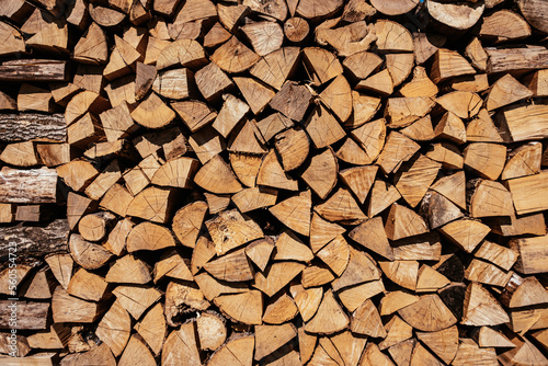 Chopped firewood is stacked in a big pile
