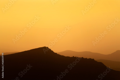 Sunrise over mountain silhouette in January 2022