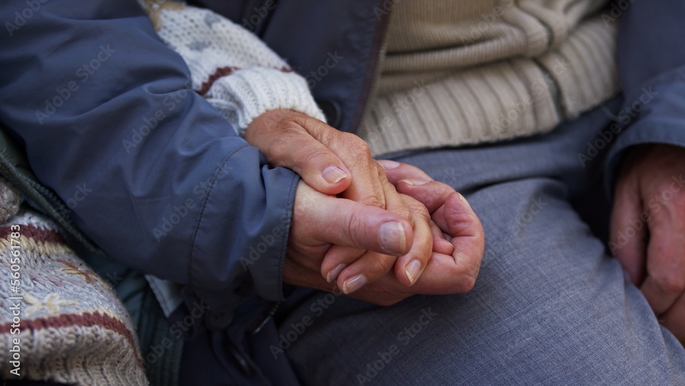 Closeup of senior couple holding hands, laced fingers. High quality photo