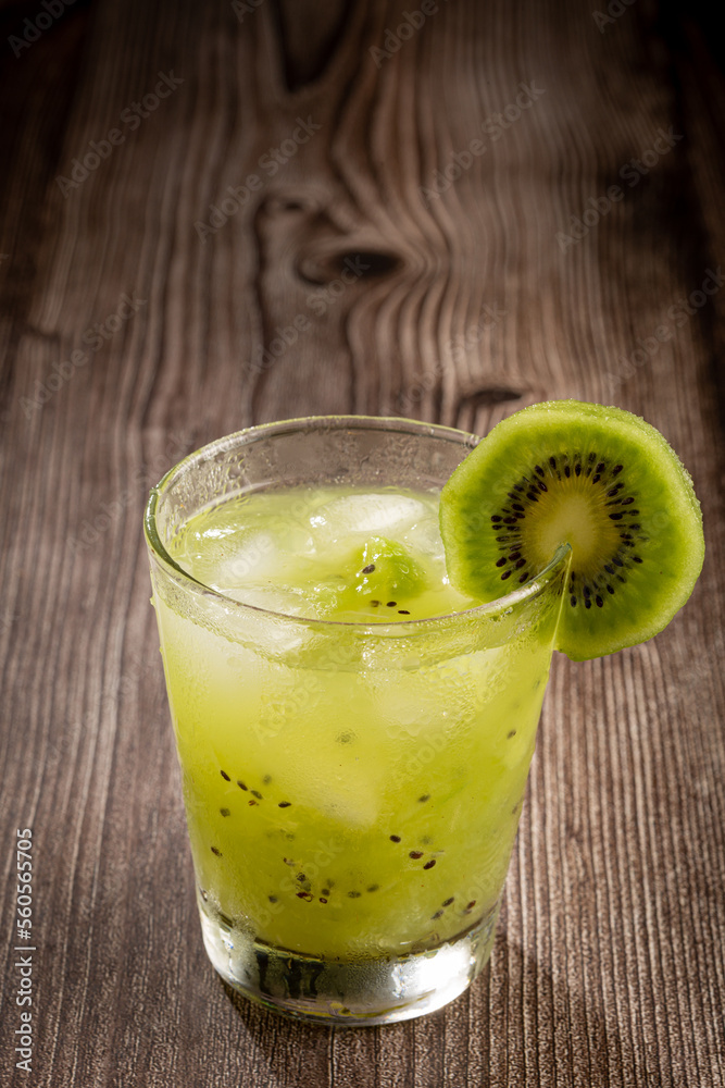 Brazilian Kiwi Caipirinha. Cachaça drink with kiwi, on wooden background. Brazilian Kiwi Caipirinha. Cachaça drink with kiwi, on wooden background.