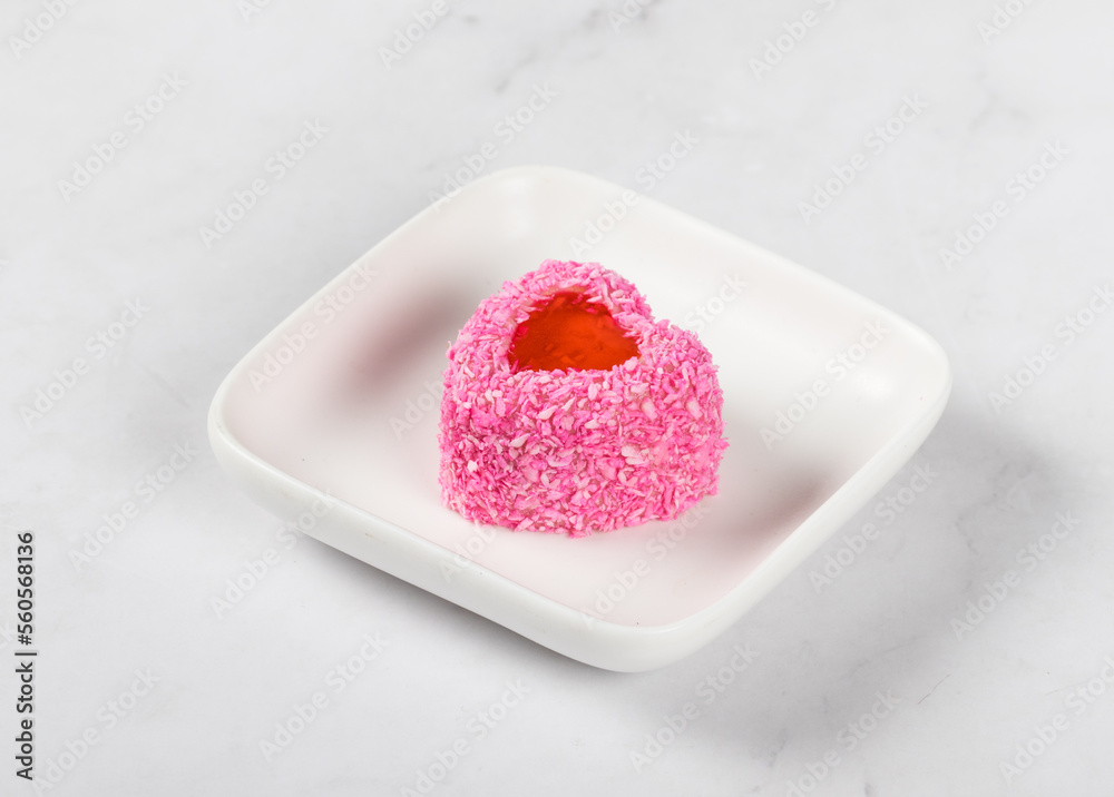 Strawberry cream mousse dessert with jelly filling, in the shape of a heart, sprinkled with pink coconut chips. On a plate. White background. Valentine's day - obrazy, fototapety, plakaty 