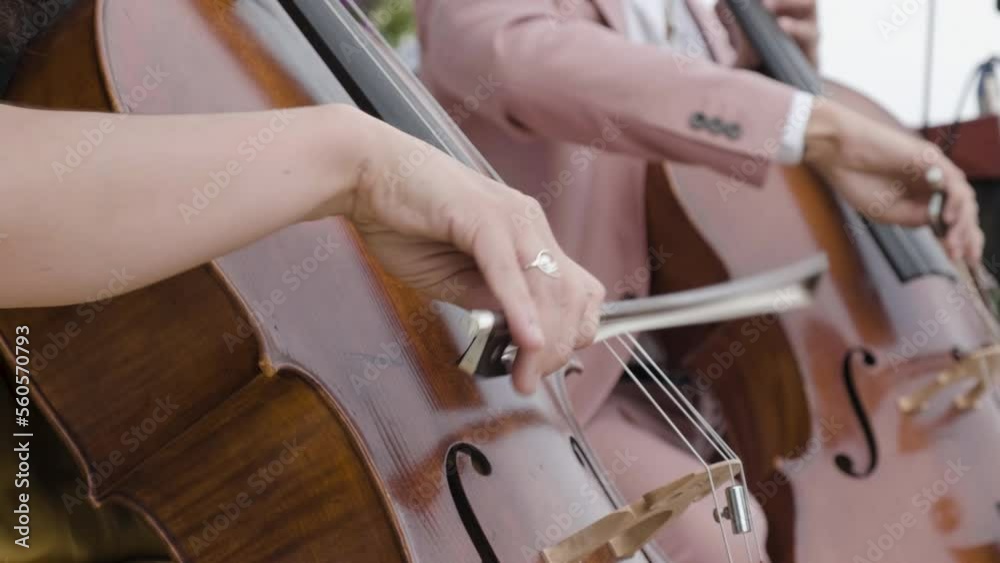 Cello ensemble playing classical music at an elegant outdoor wedding event.