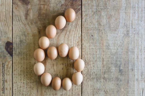 Number six written with chicken eggs, arranged on a rustic pine wood base, ideal to be used in Easter numerals.