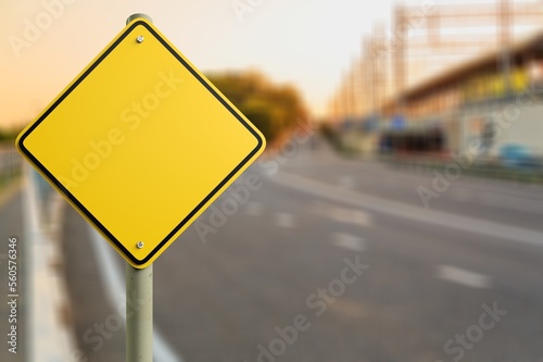 Big yellow road sign at autumn background