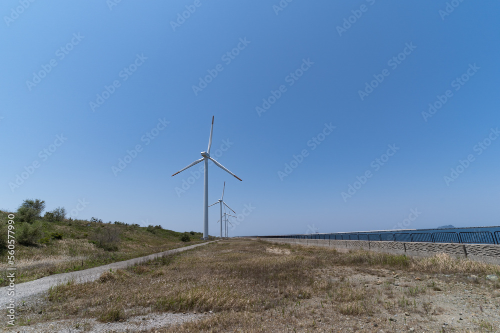 Wind power generators are on a seaside in Japan.