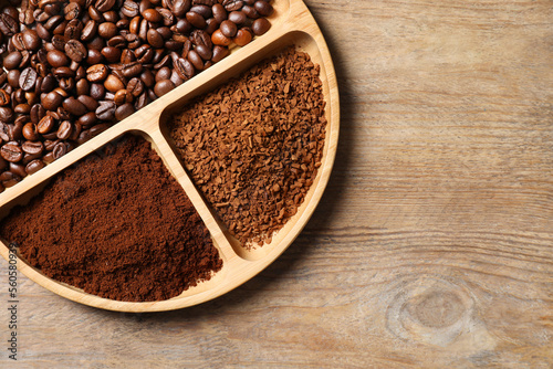 Instant  ground coffee and roasted beans on wooden table  top view. Space for text