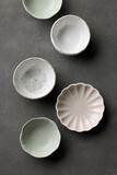 various empty bowls on dark grey background