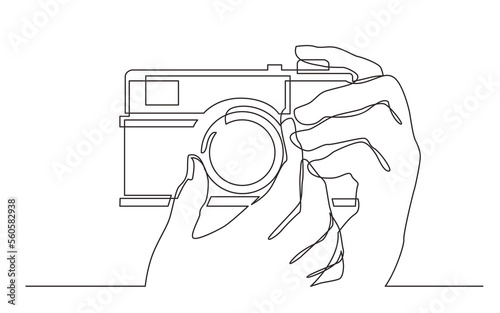continuous line drawing hand holding photo camera making pictures - PNG image with transparent background