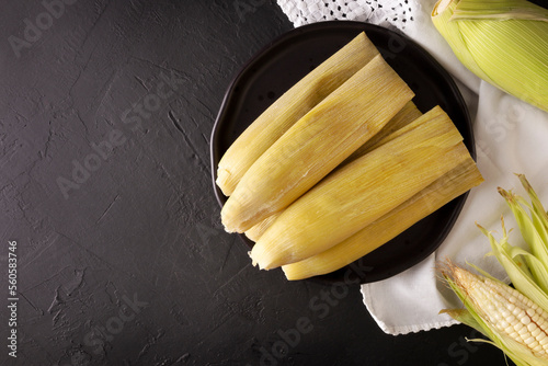 Tamales de Elote, also called Uchepos. Typical Mexican dish. Can be served with green salsa and accompanied by sour cream or served as a dessert covered with caramel or any other sweet topping photo