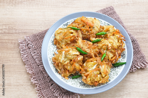 Bakwan sayur or bala-bala or vegetable fritter, Indonesian snack made from flour, cabbage, carrots and bean sprouts, served with chili
