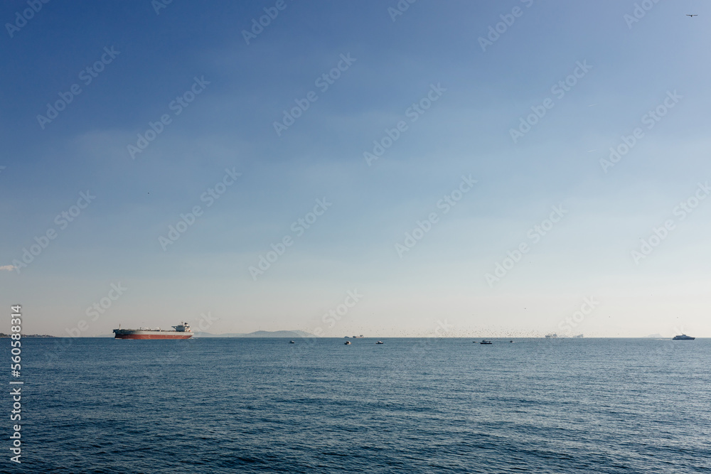 Beautiful landscape with blue sea and blue sky and a large ship in the distance on the horizon. Bosphorus, Istanbul, Turkey, 1 November 2022