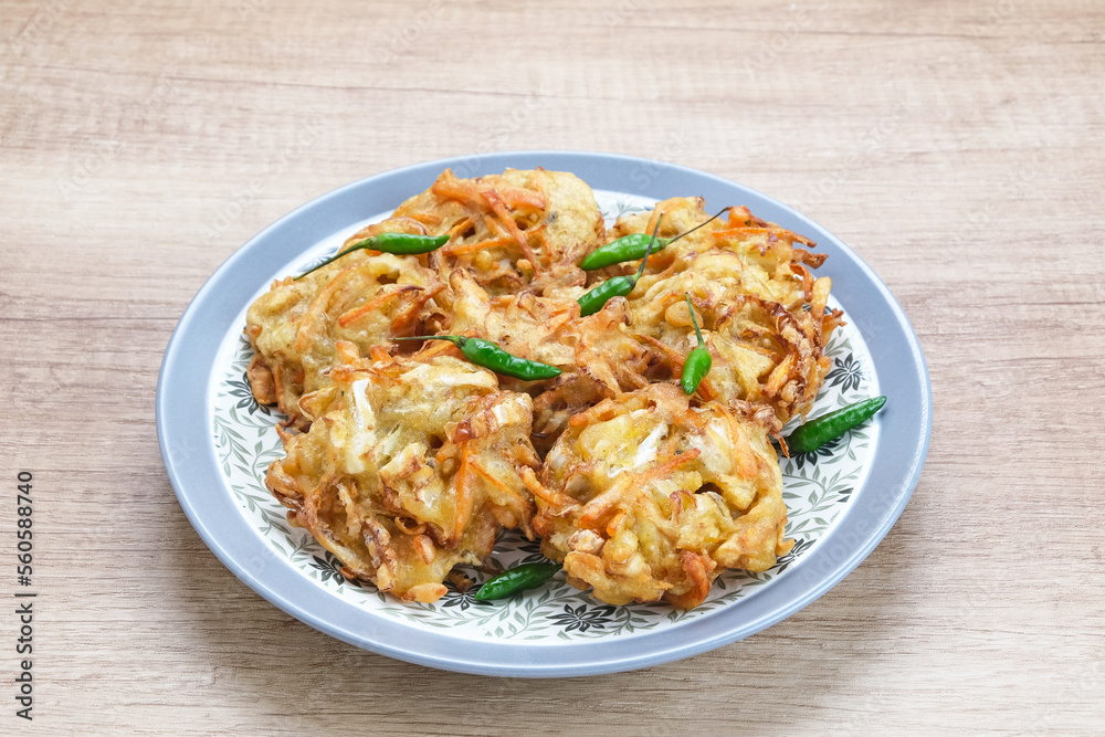 Bakwan sayur or bala-bala or vegetable fritter, Indonesian snack made from flour, cabbage, carrots and bean sprouts, served with chili
