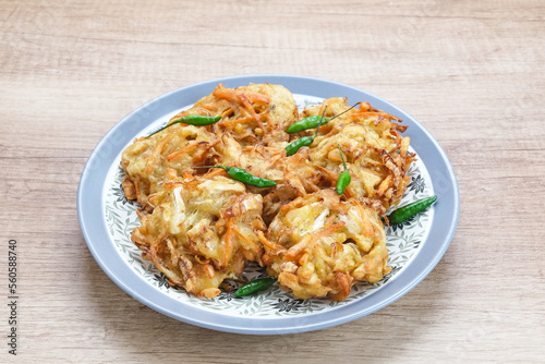 Bakwan sayur or bala-bala or vegetable fritter, Indonesian snack made from flour, cabbage, carrots and bean sprouts, served with chili 