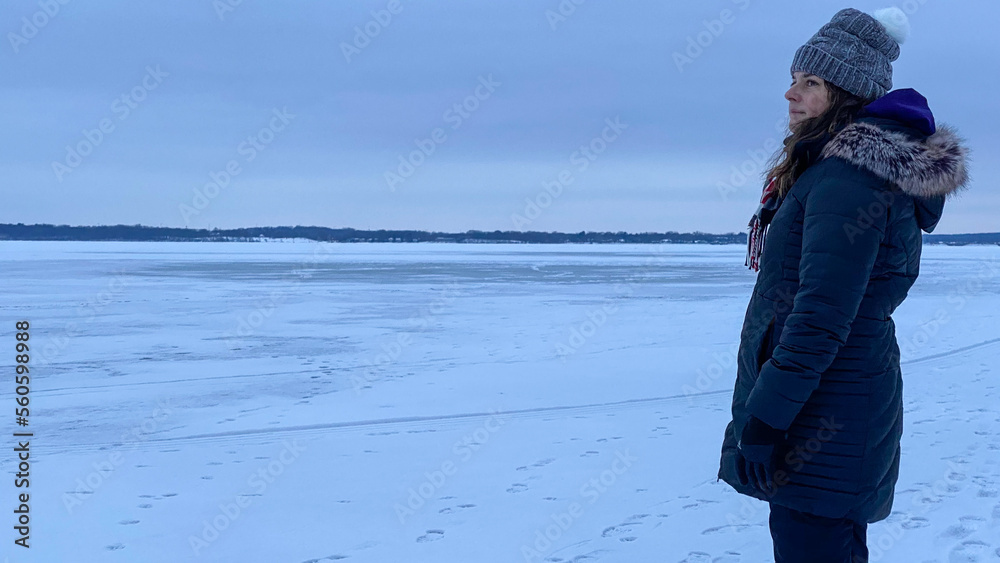 woman walking on frozen lake