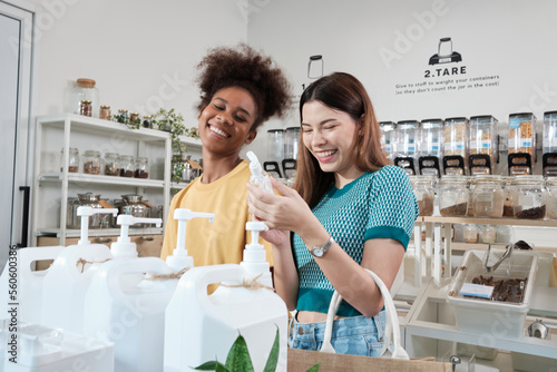 Two female customers are happy and enjoy shopping with natural organic products with recycled bottles at zero-waste and refill store, environment-friendly groceries, and sustainable lifestyles retail. photo