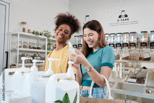 Two female customers are happy and enjoy shopping with natural organic products with recycled bottles at zero-waste and refill store, environment-friendly groceries, and sustainable lifestyles retail.