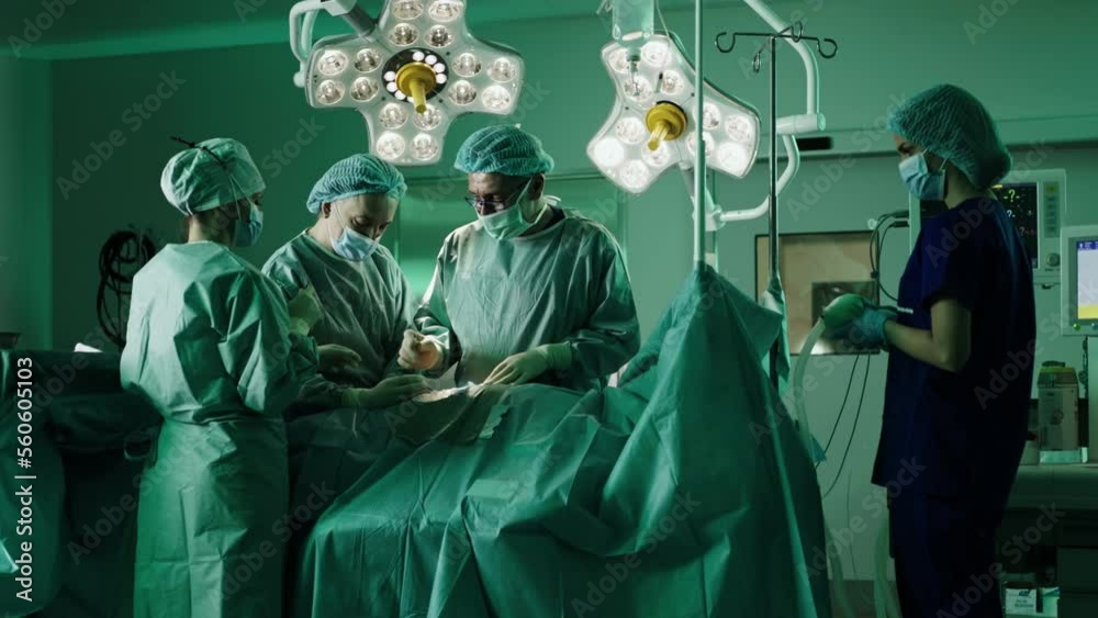 Team of proffesional doctors performing a surgery in a clinic. Team of proffesional doctors performing a surgery in a clinic.