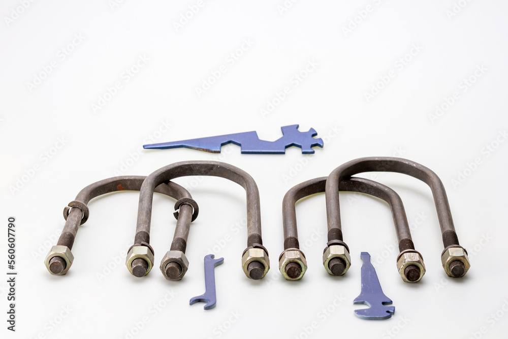 metal parts of the automobile mechanism, in the form of curved car suspension parts for mounting springs on a white milky background. metal parts of the automobile mechanism, in the form of curved car suspension parts for mounting springs on a white milky background.