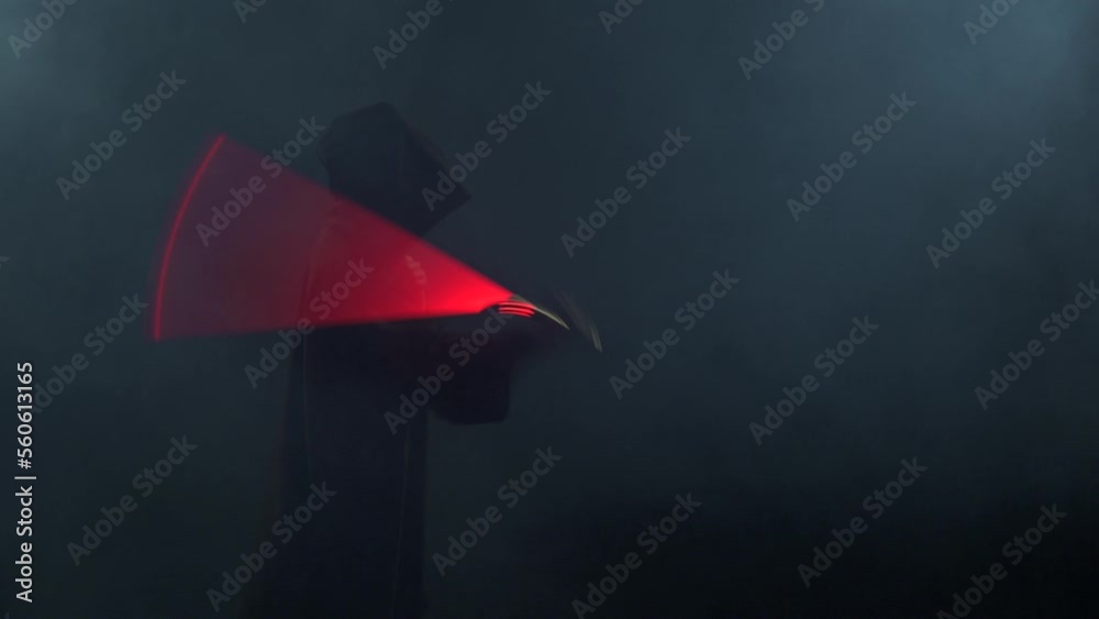 Young man in Jedi cosplay costume with lightsaber battle on black background in smoke and rain, 4k slow motion video filmed on 8k camera nikon z9