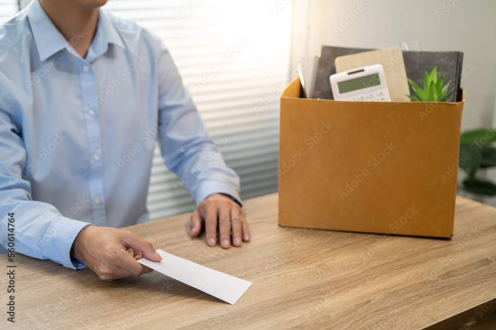 sending resignation letter to boss and Holding Stuff Resign Depress or carrying cardboard box by desk in office sending resignation letter to boss and Holding Stuff Resign Depress or carrying cardboard box by desk in office
