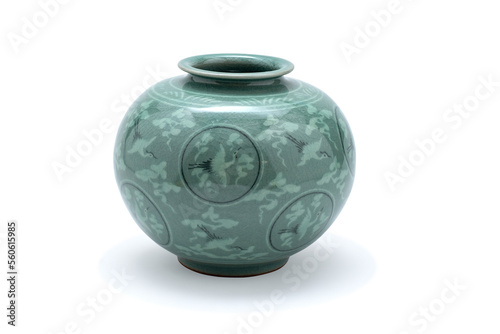 Antique Chinese enamel vase with stork flying in circle decor. Green antique ceramic flower vase. Empty decorative ceramic pot isolated on white background. Vintage porcelain handmade glaze