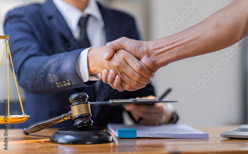 Photographie Close up of photo lawyer male notary working in a courtroom on wooden table office, Legal law, advice deal justice and law concept