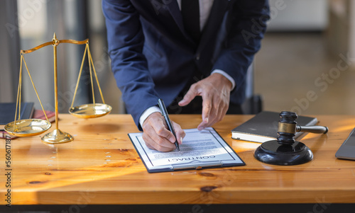 Close up of photo lawyer male notary working in a courtroom on wooden table office, Legal law, advice deal justice and law concept.