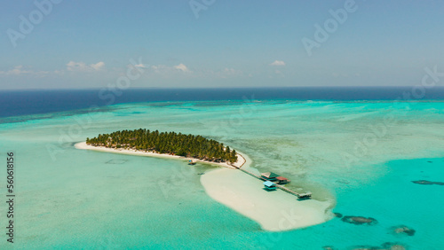 Tropical island among coral reefs with a white beach and blue atoll water. Onok Island, Balabac, Philippines. Summer and travel vacation concept photo