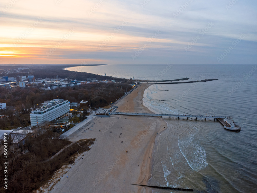 Aerial view. Seascape. The setting sun. Beach, sand, sea , water , waves. Winter season. Photo from a drone.