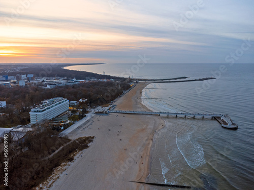Obraz na płótnie Aerial view. Seascape. The setting sun. Beach, sand, sea , water , waves. Winter season. Photo from a drone. w salonie