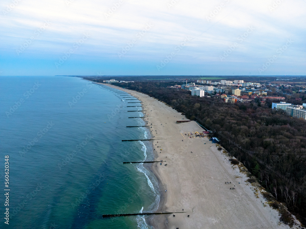Aerial view. Seascape. The setting sun. Beach, sand, sea , water , waves. Winter season. Photo from a drone.