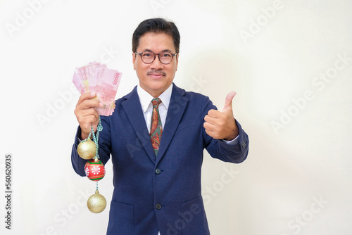 Manager showing cash money and some crystal balls in right hand for Christmas 2023 holidays photo