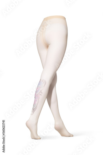 Detailed shot of beige tights with a color print imitating tattoo at the back. The tattoo-effect pantyhose have a shape of walking women's legs. The clothes are isolated on a white background.