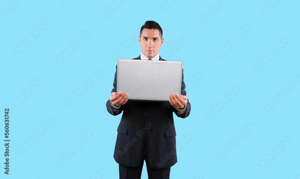 A young business man with a laptop computer A young business man with a laptop computer