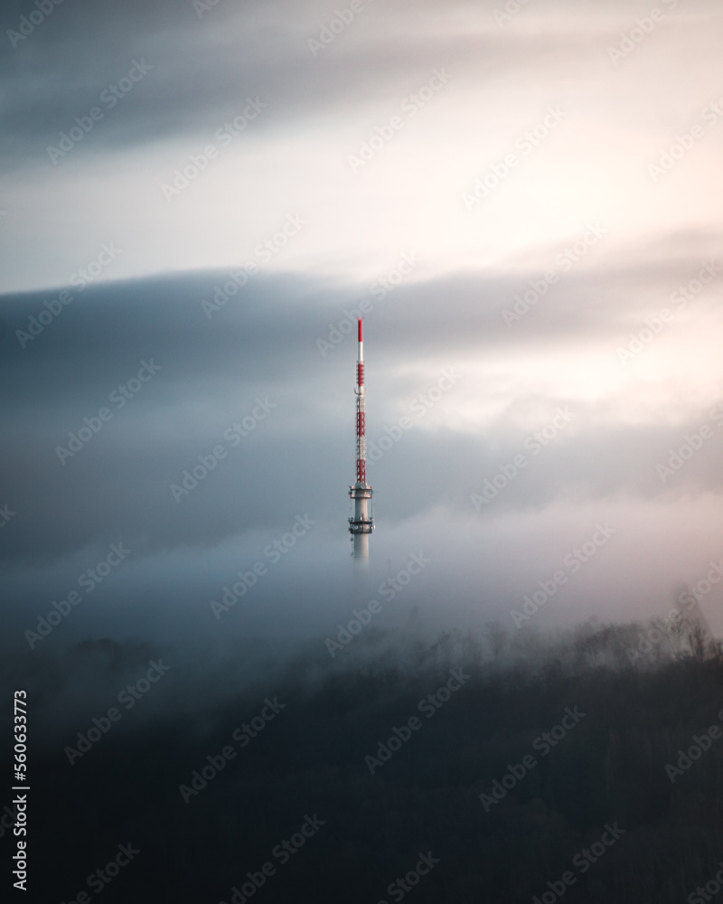 Obraz premium German SWR broadcasting tower in the morning surrounded by clouds