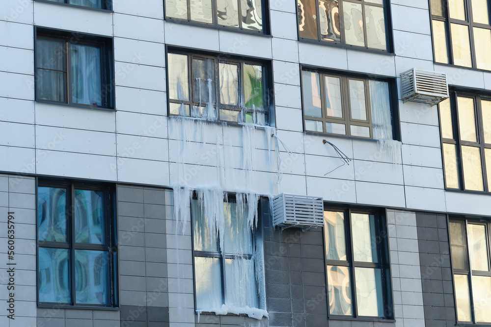 icicle on the windows and glass of a modern house due to an accident in the heating system. icicle on the windows and glass of a modern house due to an accident in the heating system.