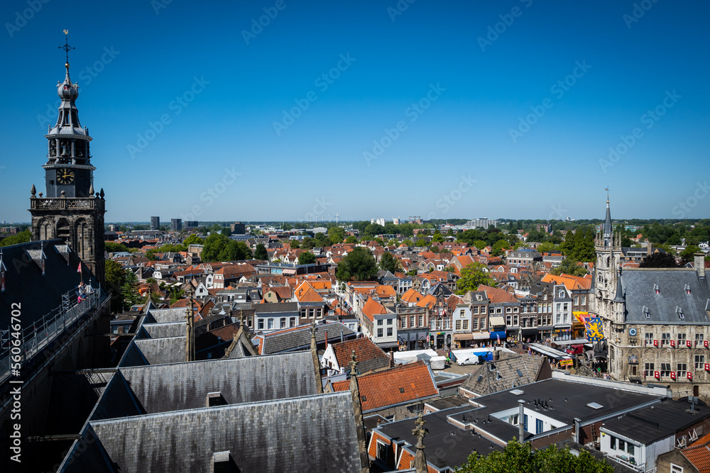 Fototapeta premium A view from the top of Saint Johns Church in Gouda looking out over the rooftops of the pretty town on a sunny summer day. The gothic building is a stunning attraction for tourists in the Netherlands