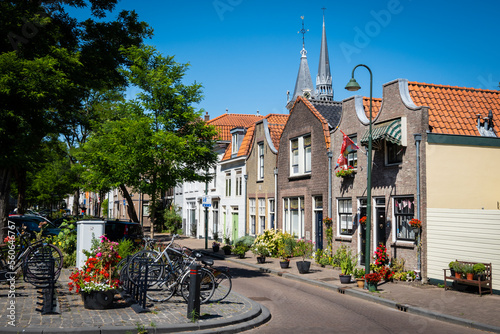 Fotografie A typical Dutch street in Gouda in the Netherlands on a sunny summer day