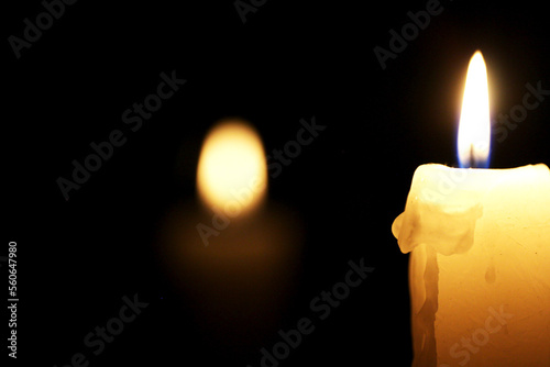 Burning candle with reflection.
