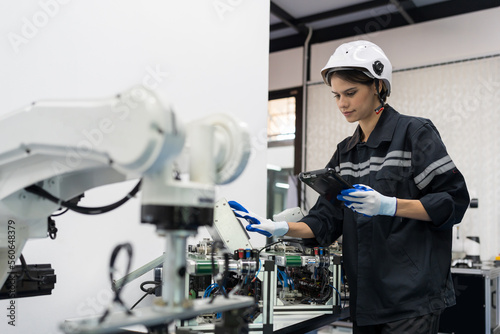 Female engineer control autonomous mobile robot or AMR in the manufacturing automation and robotics academy room. Woman engineer training or maintenance AI robot photo