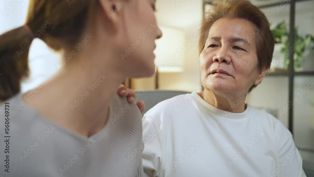 Asian adult senior mother consoling sad daughter at home. caring senior mom giving support understanding empathy to stressed adult woman in tears. Asian adult senior mother consoling sad daughter at home. caring senior mom giving support understanding empathy to stressed adult woman in tears.
