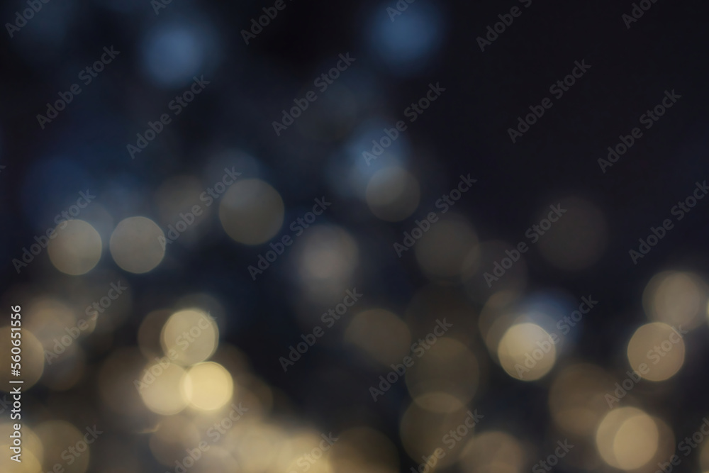 Blurred magic fairy lights with an abstract bokeh effect against a dark background