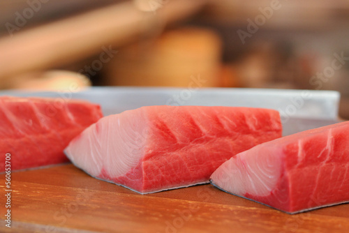 Hamachi raw fish on wooden plate.