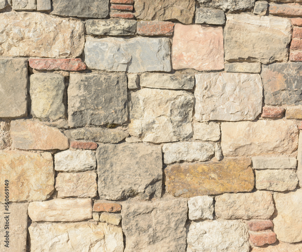 Fototapeta premium Masonry of ancient stones with uneven texture