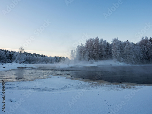 Strong frost in January on the Shuya River in the Republic of Karelia, northwestern Russia.
Steam over water. The waterfall in the river is partially frozen.